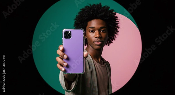 Fototapeta Stylish young person holding modern phone with vibrant lavender case against dynamic background, perfect for tech, lifestyle, and creative campaigns