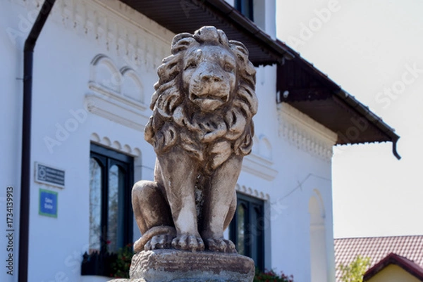 Obraz lion statue in front of a church