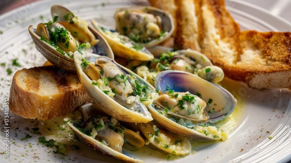 Fototapeta Creamy Garlic Butter Clams with Fresh Herbs and Toasted Bread on White Plate
