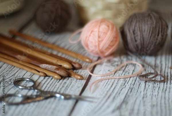 Obraz Clews balls of yarn wool and crochet hooks and a basket photo 
