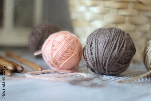 Obraz Clews balls of yarn wool and crochet hooks and a basket photo 