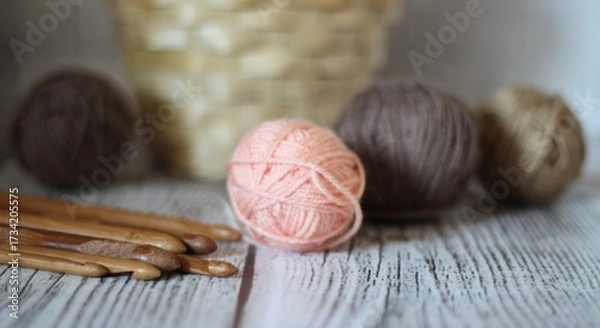 Obraz Clews balls of yarn wool and crochet hooks and a basket photo 