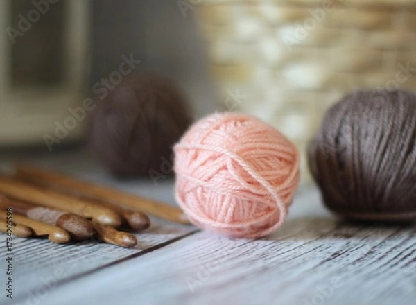 Obraz Clews balls of yarn wool and crochet hooks and a basket photo 