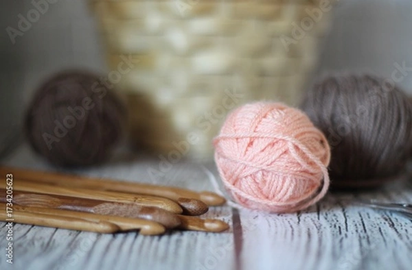 Obraz Clews balls of yarn wool and crochet hooks and a basket photo 