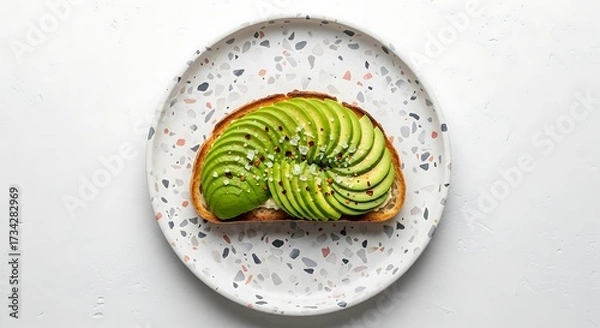 Fototapeta Avocado Toast on Decorative Plate with Sprinkles on White Background
