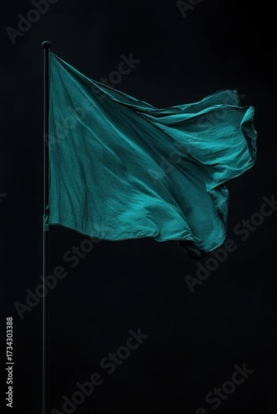 Fototapeta Dark teal silk flag waving on black background with elegant folds