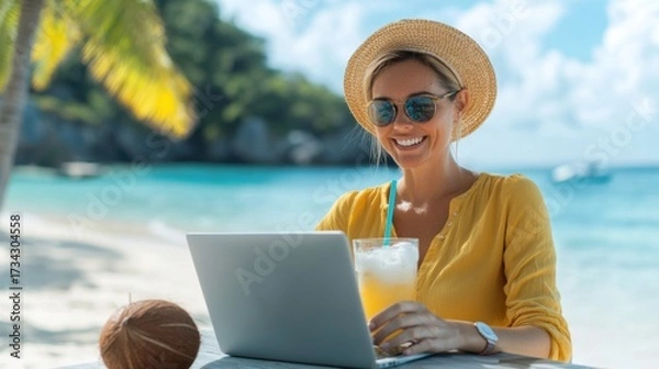 Fototapeta Smiling woman working on laptop at tropical beach with palm trees and ocean view