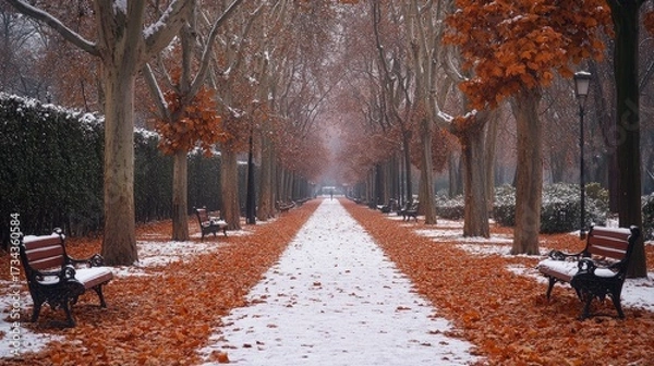 Fototapeta Experience the serene beauty of a snow-dusted park in autumn, inviting a quiet moment of reflection amidst the falling leaves and gentle winter chill, perfect for seasonal campaigns