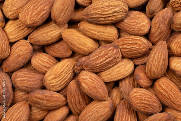Fototapeta Whole almond nuts closeup, top view
