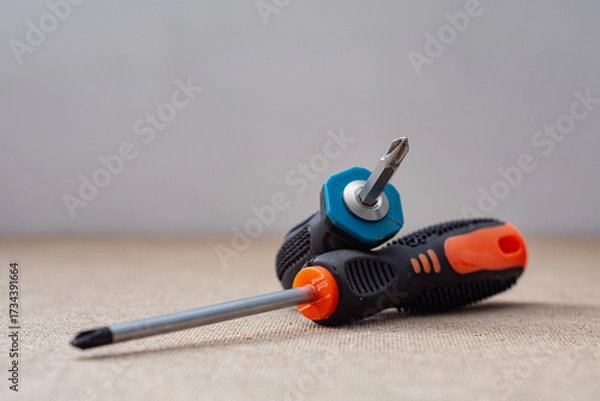 Fototapeta Two screwdrivers on a wooden background. Professional hand tool for construction, repair and DIY projects.