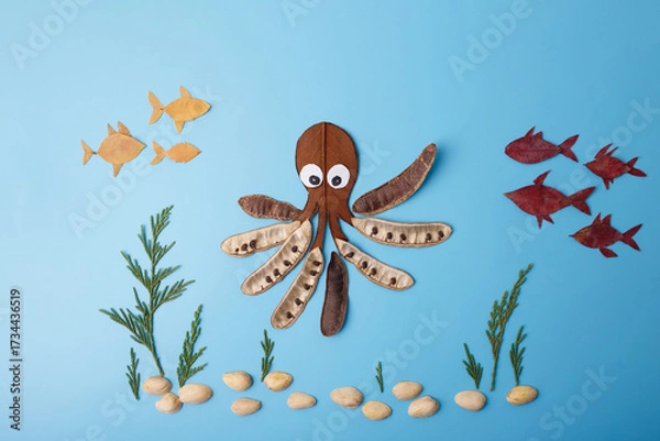 Fototapeta diy handmade flat lay composition with octopus and fish created from natural leaves pods and seeds on blue background creative marine concept useful for eco education publishing children products,