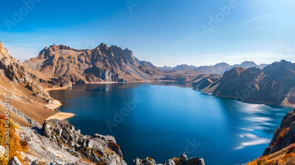 Obraz The Changbaishan Tianchi: A Majestic Volcanic Crater Lake on the China-North Korea Border in Jilin, China—Boasting Crystal-Clear Blue Water, Surrounded by Snow-Capped Peaks & Coniferous Forests, Ideal