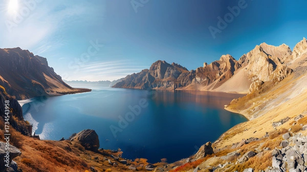 Obraz The Changbaishan Tianchi: A Majestic Volcanic Crater Lake on the China-North Korea Border in Jilin, China—Boasting Crystal-Clear Blue Water, Surrounded by Snow-Capped Peaks & Coniferous Forests, Ideal