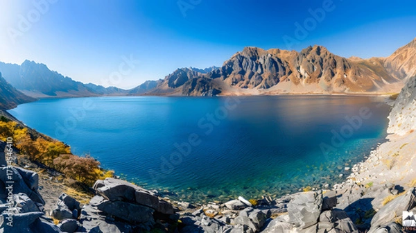 Obraz The Changbaishan Tianchi: A Majestic Volcanic Crater Lake on the China-North Korea Border in Jilin, China—Boasting Crystal-Clear Blue Water, Surrounded by Snow-Capped Peaks & Coniferous Forests, Ideal