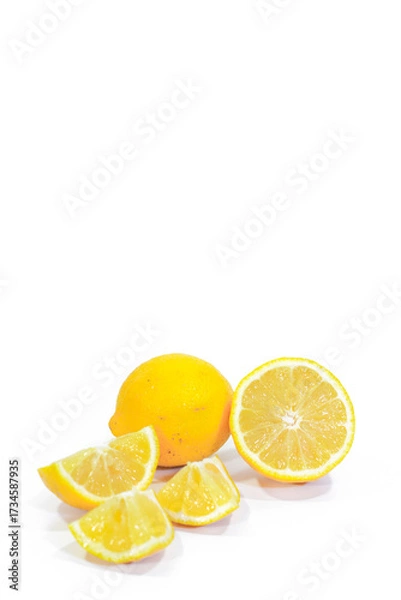 Fototapeta Whole, Halved, and Sliced Lemons on a White Background