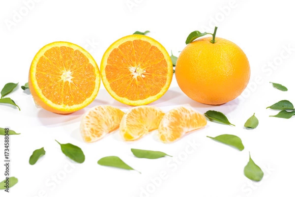 Fototapeta Whole, Halved, and Segmented Valencia Orange with Leaves on a White Background