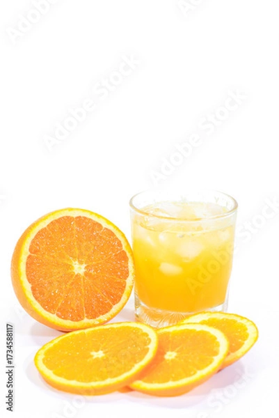 Fototapeta Glass of Valencia Orange Juice with a Whole and Sliced Oranges on a White Background