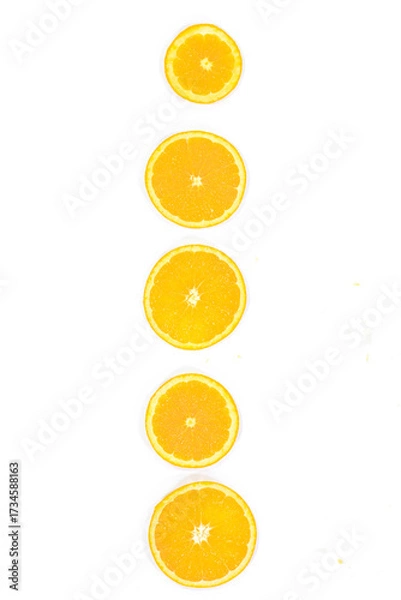 Fototapeta Top View of Sliced Valencia Oranges Arranged in a Vertical Line on a White Background