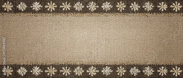Fototapeta This cozy winter-themed banner features a brown and white rug with a lovely floral pattern. The knitted texture border is adorned with delicate snowflakes, creating a warm and inviting atmosphere.