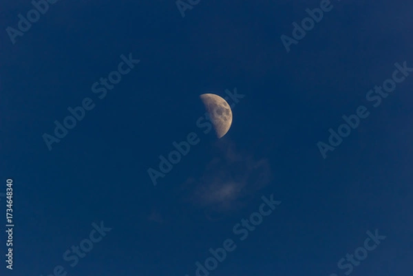 Fototapeta Moon in the blue sky with white clouds, 