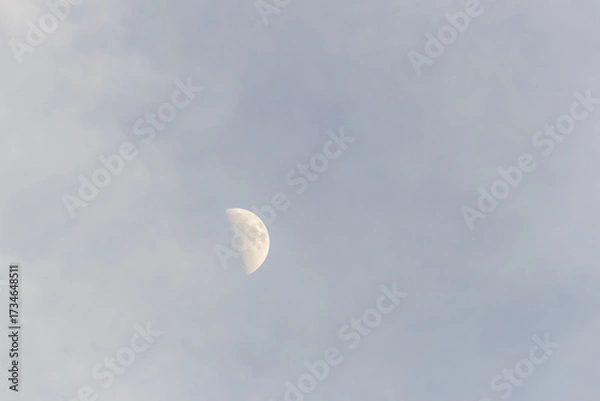 Fototapeta Moon in the blue sky with white clouds, 