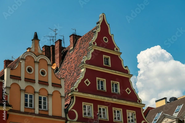 Obraz Ornate historic facades dominate the scene as colorful gabled townhouses stand side by side under a clear blue sky, capturing the charm of Wroclaw, Poland’s vibrant city center architecture.