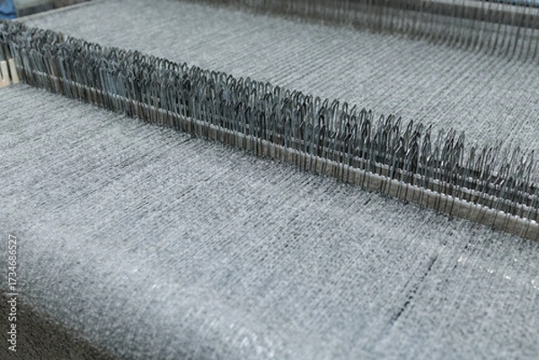Fototapeta Boucle fabric loops on industrial machine during textile production