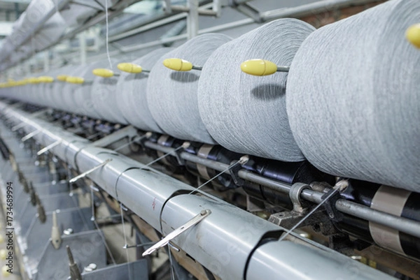 Fototapeta Yarn rolls on warping machine in modern textile factory