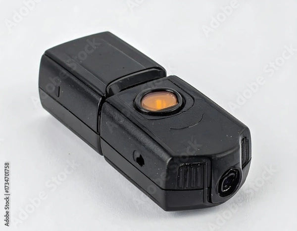 Fototapeta Black portable device with orange button