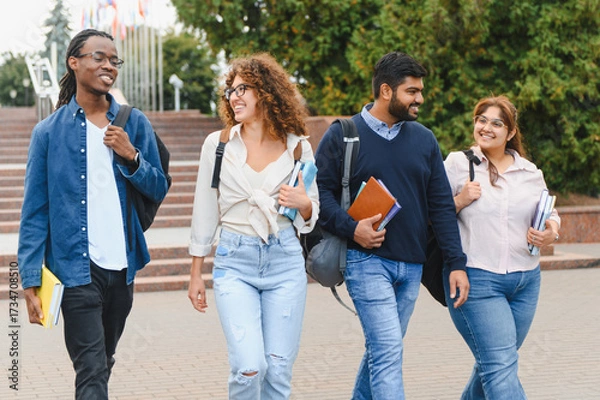 Fototapeta Diverse students walking on campus engaging conversations