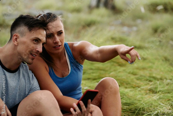 Fototapeta Romantic Couple Planning New Running Routes in the Forest with Smartphone