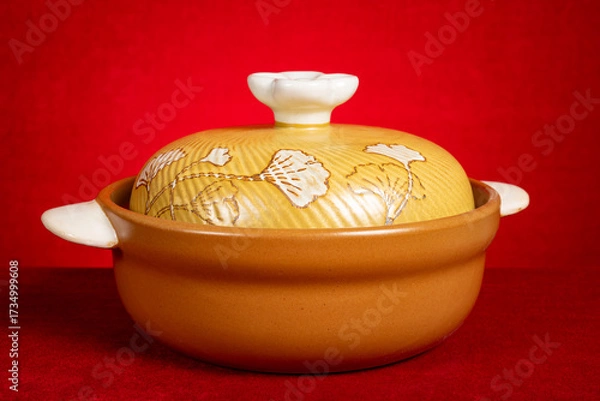 Fototapeta angle view rustic ceramic pot on red