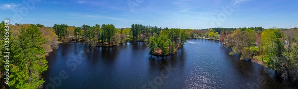 Fototapeta Johnson Pond aerial view on Forge River in spring at the historic center of Raynham, Bristol County, Massachusetts MA, USA. 