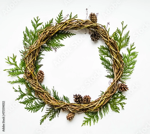 Fototapeta Festive wreath of vines with thuja branches and cones. Flat lay, top view