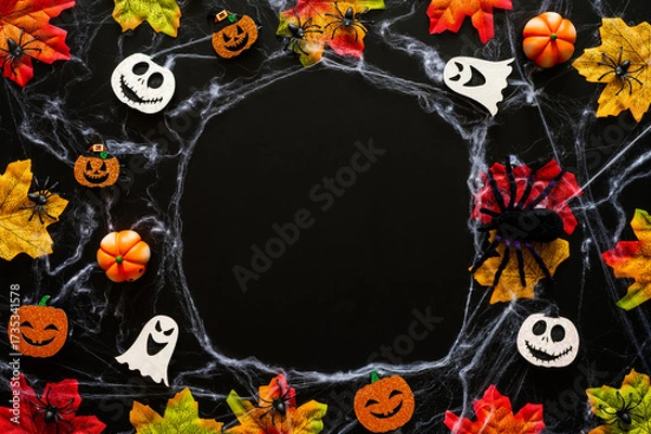 Fototapeta Halloween party decorations on cobweb with maple leaves on black background for Halloween holiday concept.
