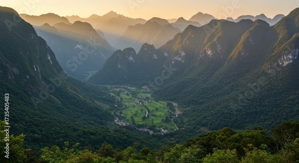 Fototapeta Dramatic aerial view of a vast mountain range with valley featuring natural landscape and sunlight