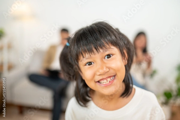 Fototapeta Joyful Family Moments: Capturing an innocent child's heartwarming smile, radiating pure joy and a sense of togetherness, framed within the warmth of a family's love. 