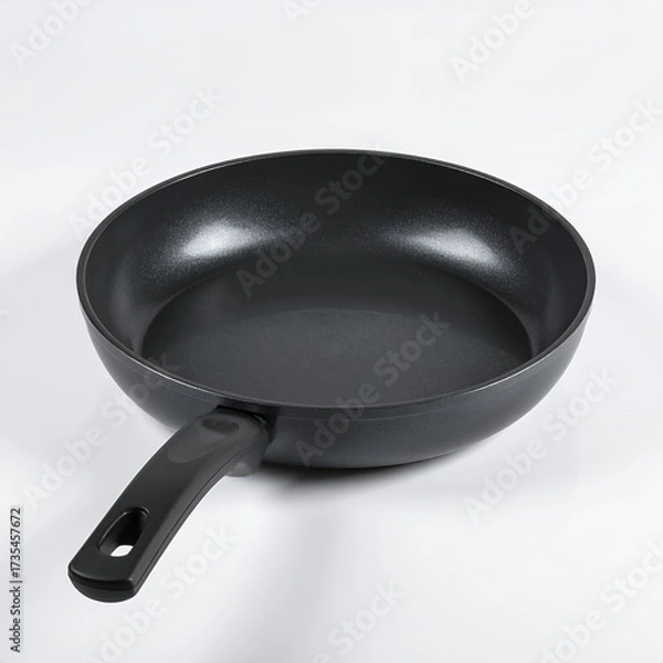 Fototapeta Sleek black frying pan isolated against a pristine white background kitchen utensil