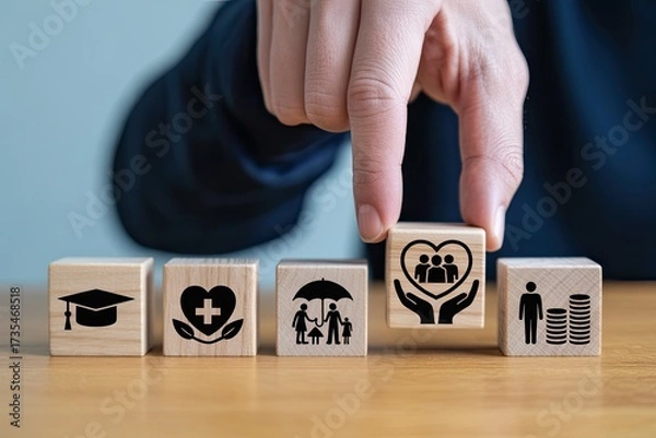 Fototapeta Hand placing wooden block with family care symbol on a row of financial planning icons