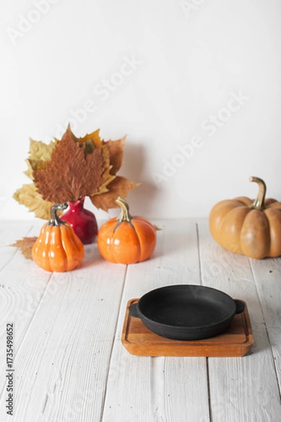 Fototapeta Autumn Still Life with Pumpkins and Empty Serving Dish on Rustic Table