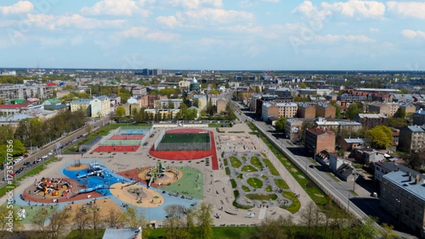 Fototapeta Aerial Drone View Of Riga Panorama In Latvia On A Sunny Spring Day Showcasing The Rooftops Of Houses The Vibrant City Center Historic Buildings And Barona Street Playground of the Downtown Sports Area