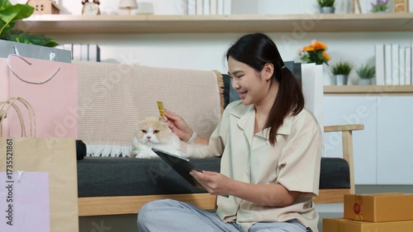 Fototapeta Happy Shopper Enjoying Online Purchases with Cat