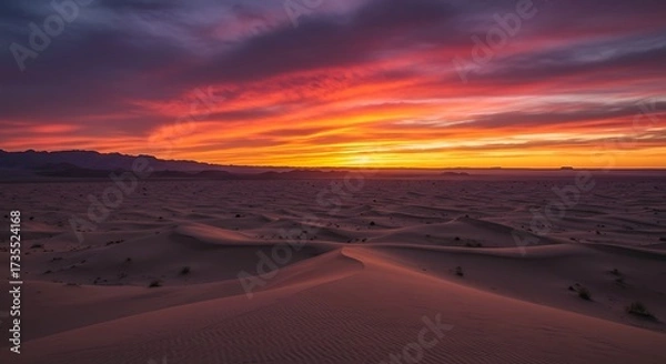 Fototapeta Vibrant sunset over desert landscape with dunes and colorful sky