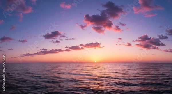 Fototapeta Vibrant sunset over ocean with dramatic clouds and colorful sky