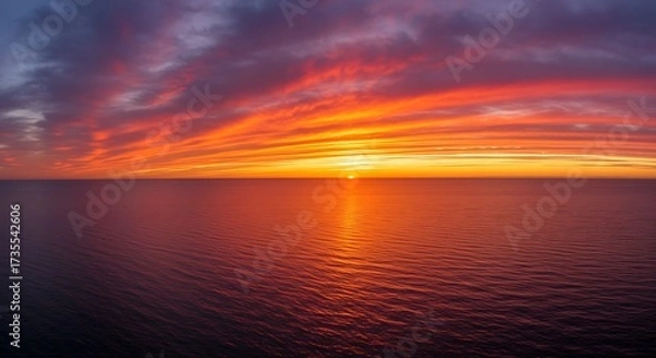 Fototapeta Vibrant sunset panorama over the ocean with colorful clouds and horizon