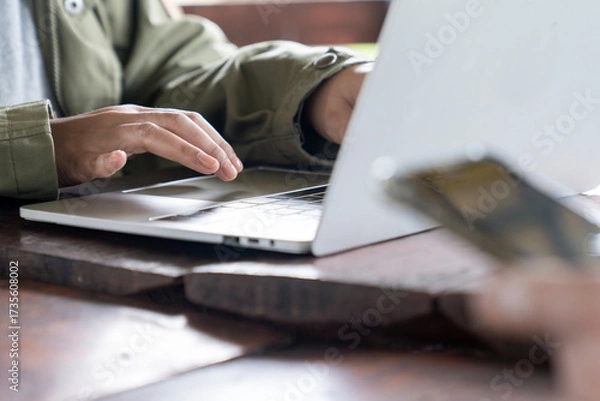Fototapeta Female hands typing on laptop keyboard, close-up view, concept of work, study, online communication, and modern digital lifestyle.
