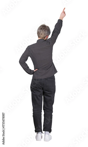 Fototapeta Rear view full length portrait young woman pointing finger up, hand raised showing or celebrating. Business female isolated on transparent background