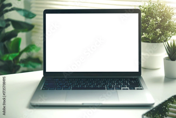 Fototapeta Laptop mockup with blank white screen on a green round table in window light. home office scene for UI previews, web banners, presentations, and product marketing.