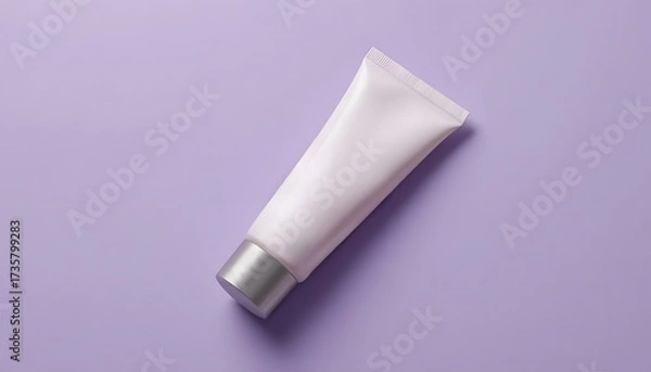 Fototapeta Elegant white cosmetic tube with silver cap on calming lavender background for skincare or beauty product marketing materials and social media campaigns