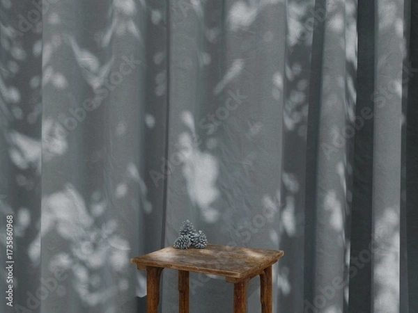 Fototapeta Wooden table with pine cones against slate blue curtain, soft sunlight and shadow background interior mockup